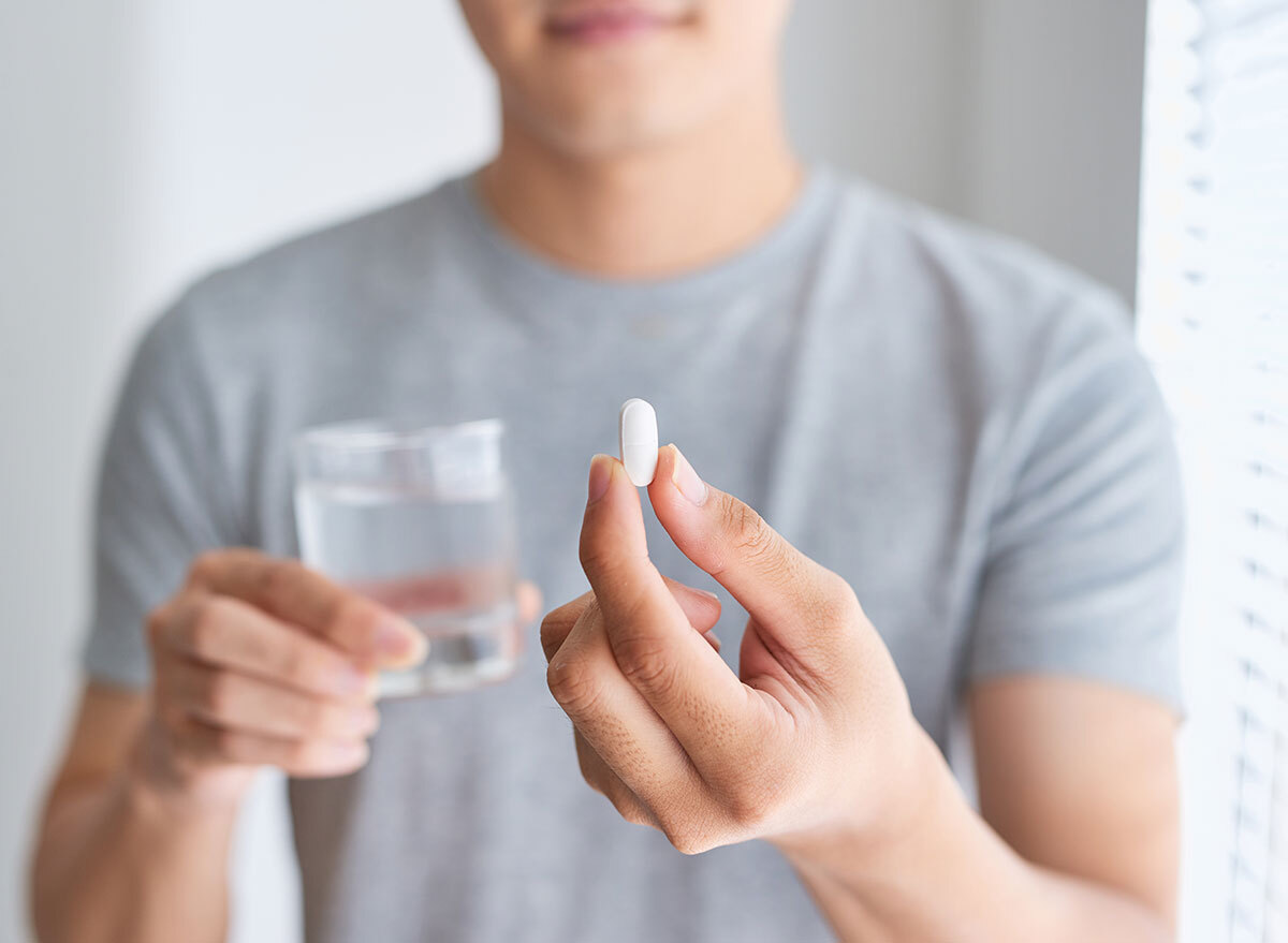 man holding pill