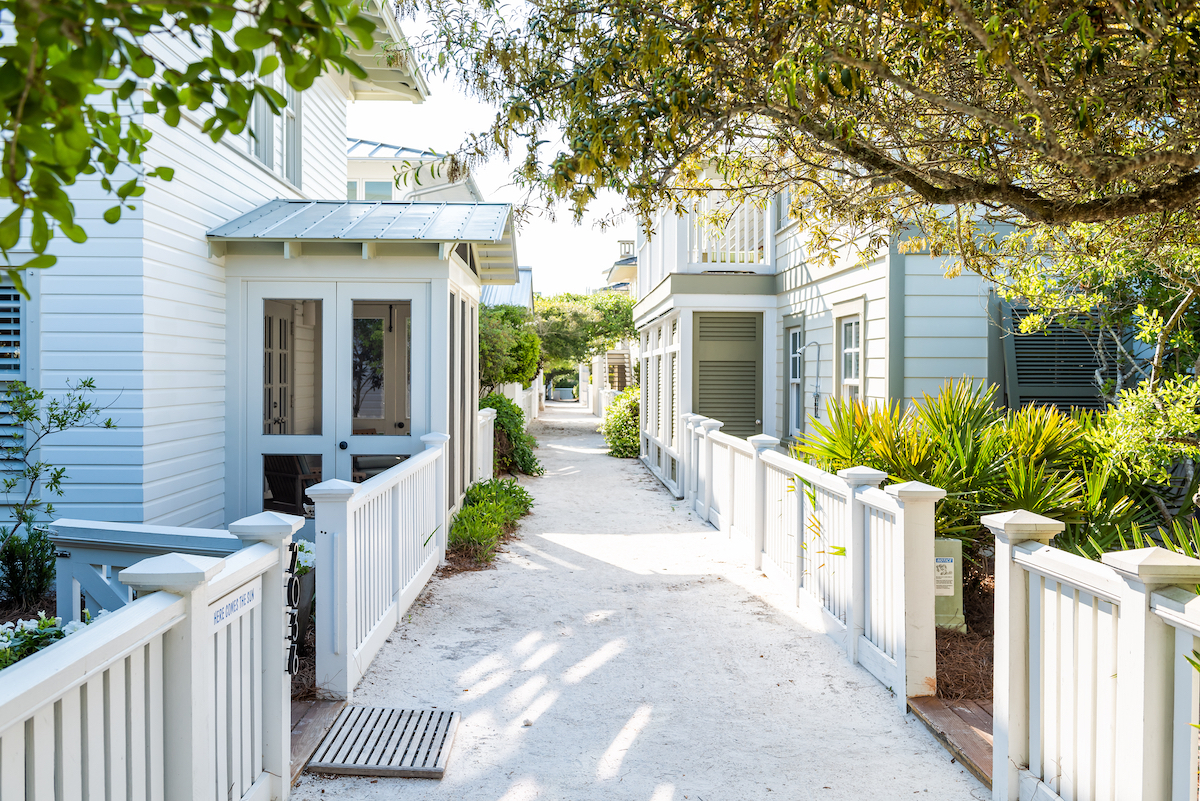 A sandy path between two rows of white houses in Seaside, Florida