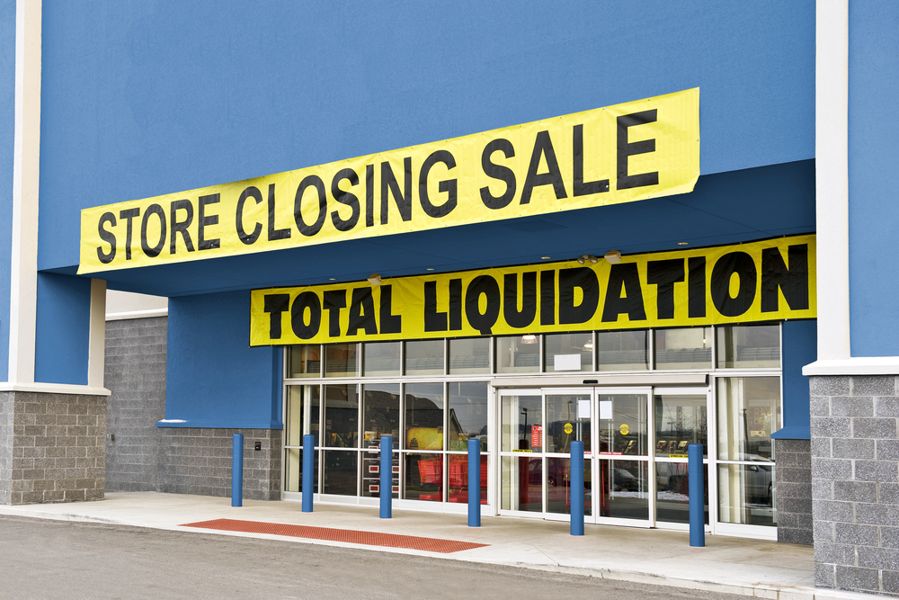 A storefront covered in going out of business signs