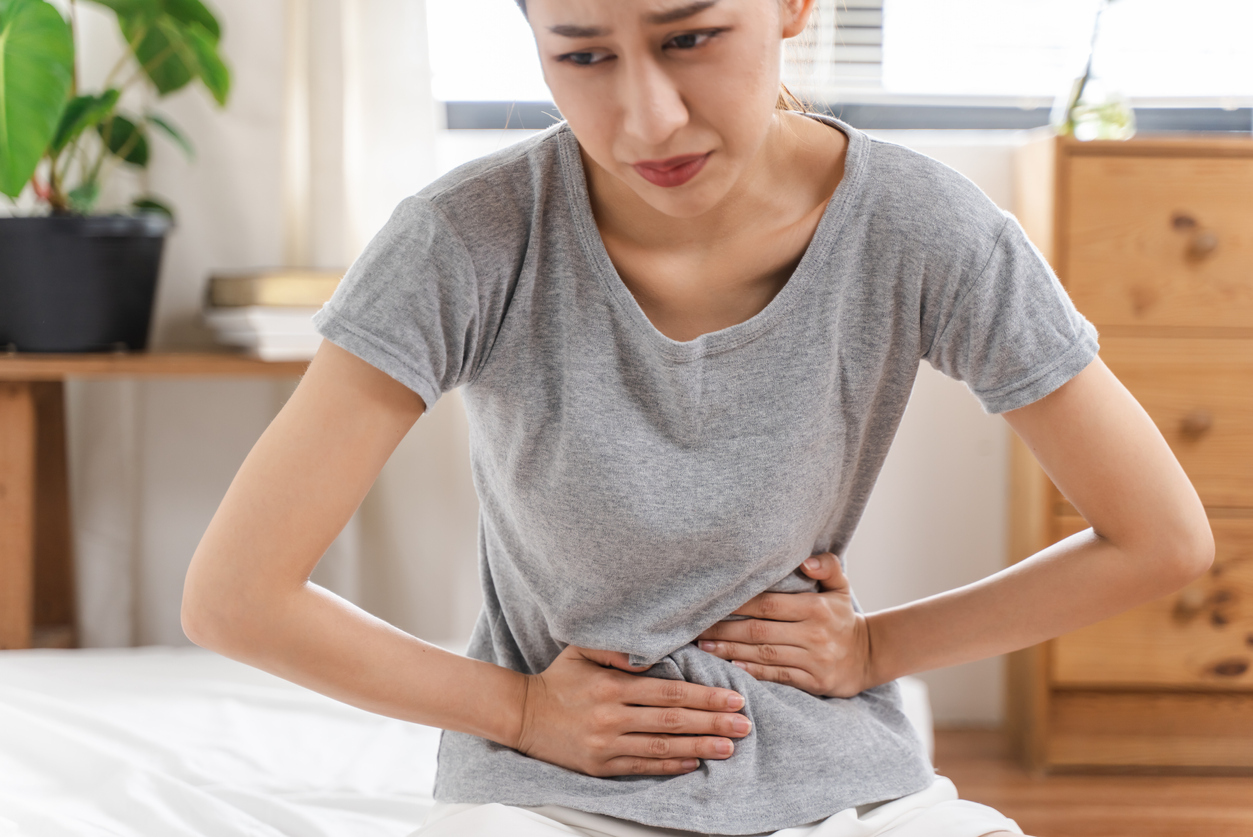 Woman with her hands on her stomach.