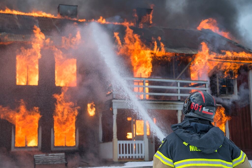 firefighter putting out a house fire