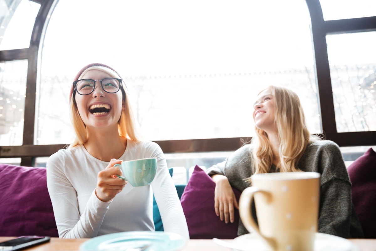 Two Women Laughing on the Couch