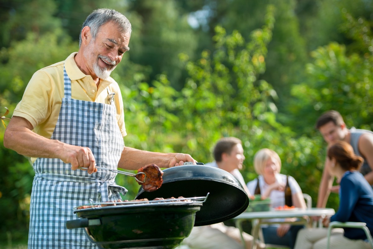 Senior man grilling