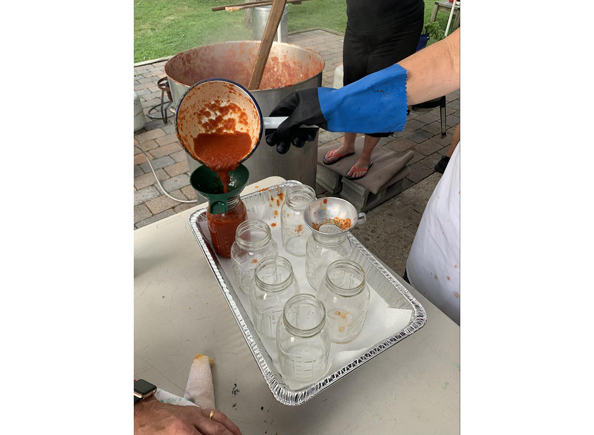 homemade sauce pouring in jars