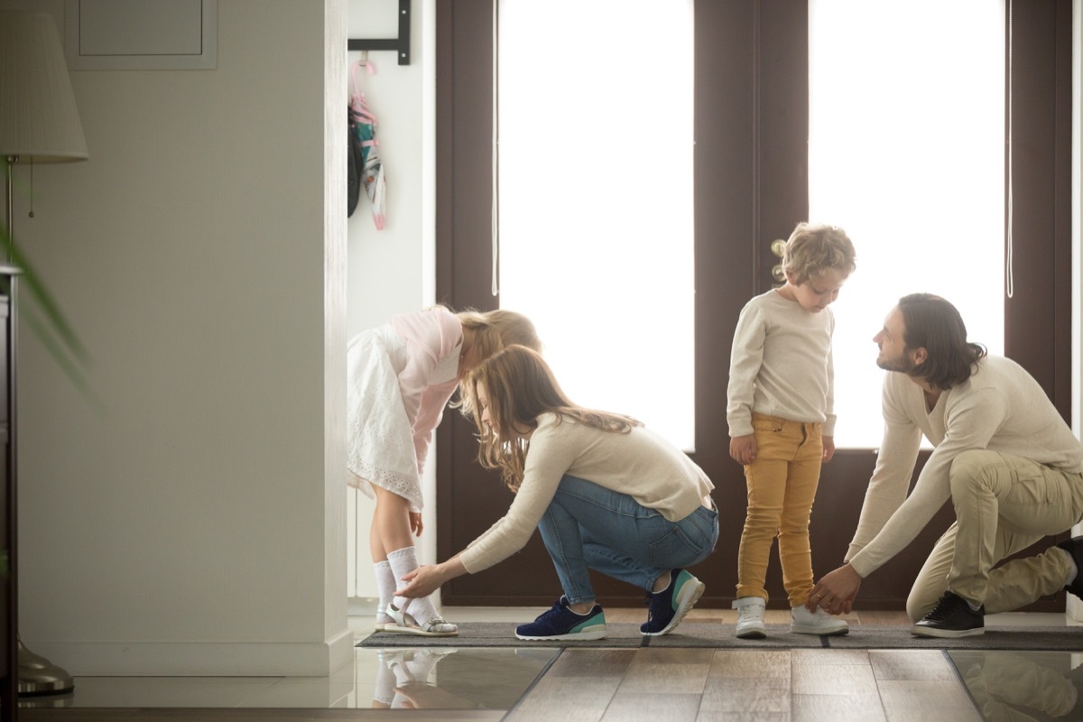 parents putting shoes on children back-to-school tips