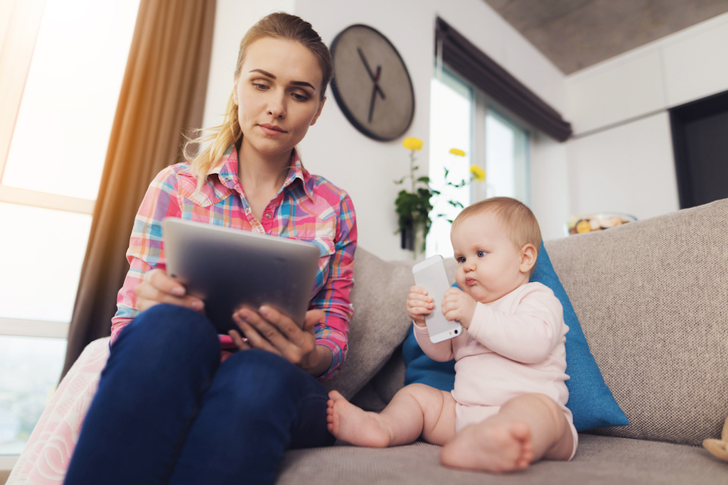 woman reads tablet, stay at home mom