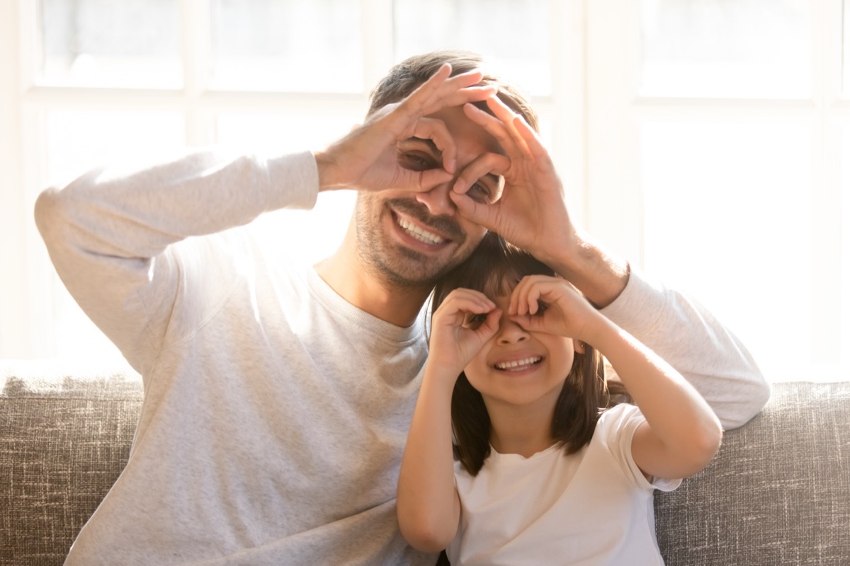 father and daughter making silly faces at home