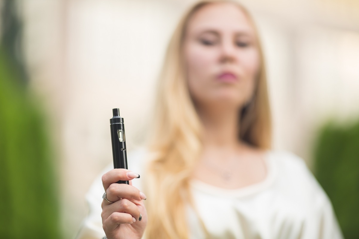 woman handing vape