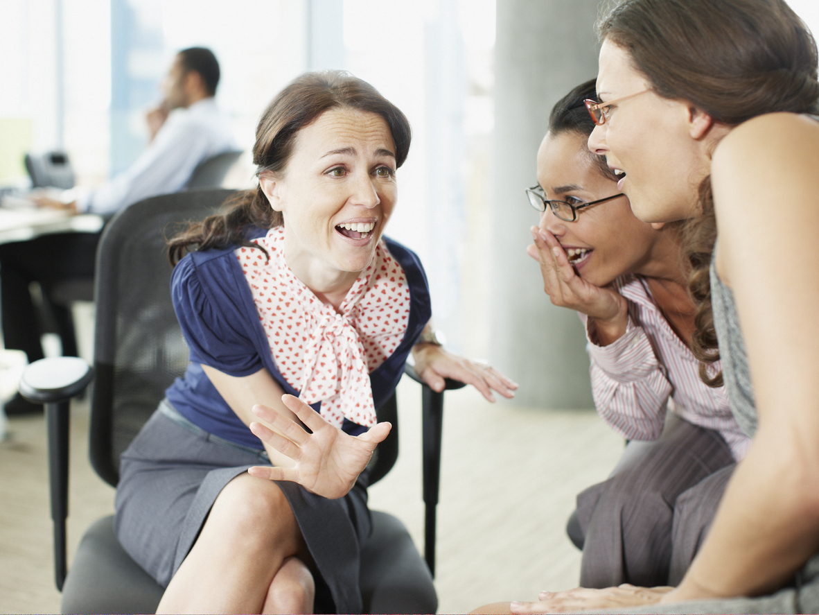 Businesswomen gossiping in the office.