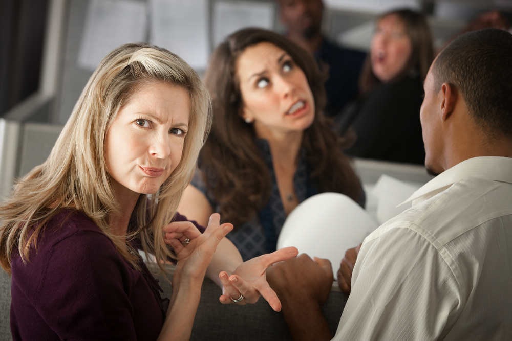 woman frowning and pointing to another woman