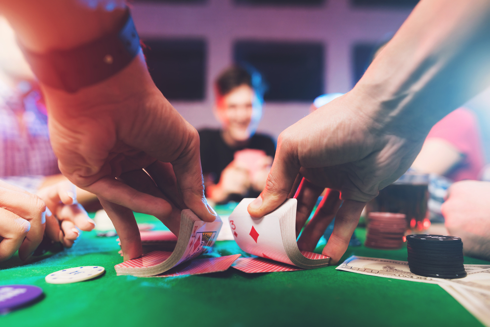 A closeup of a dealer shuffling cards during a game