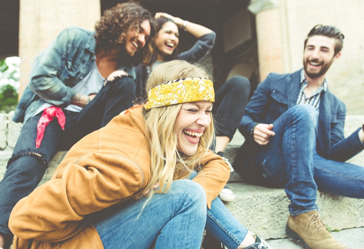 group of friends laughing outside in response to random 