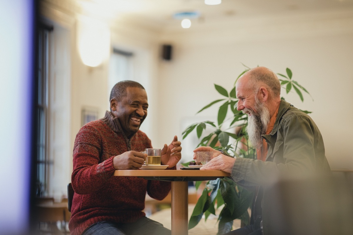 two old friends reconnecting in a coffee shop