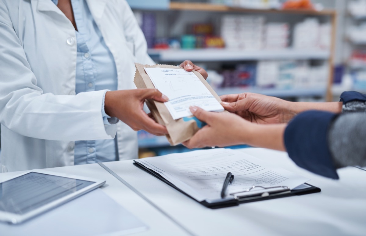 Closeup shot of an unrecognizable pharmacist assisting a customer in a chemist