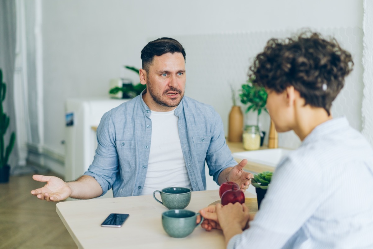 man being rude at dinner with a woman