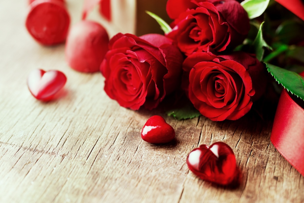 Rose bouquet and hearts on a wooden baord