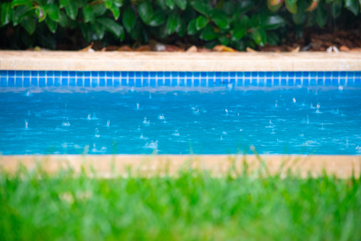 Close up of rain drops falling in the swimming pool