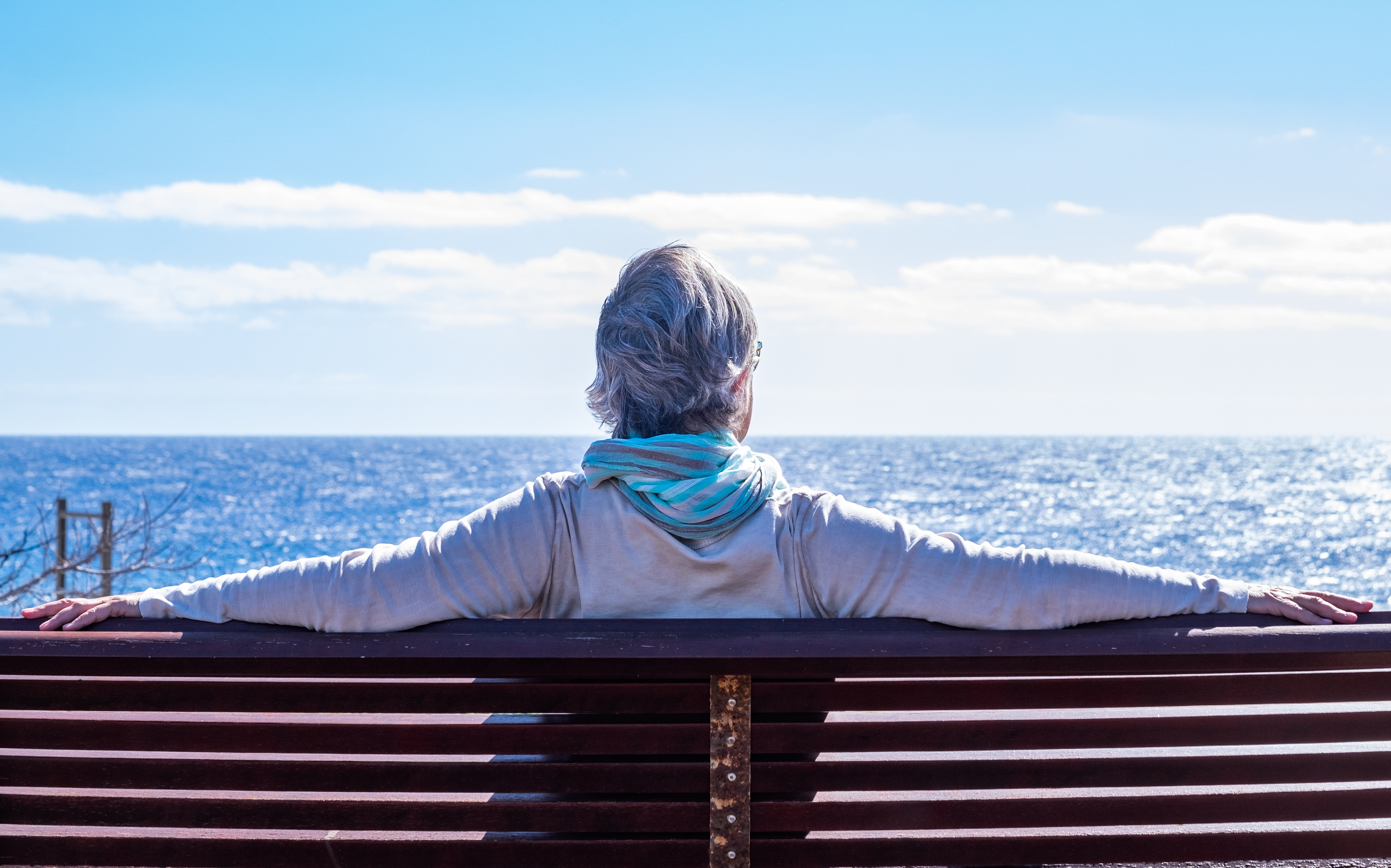 person on bench at the beach