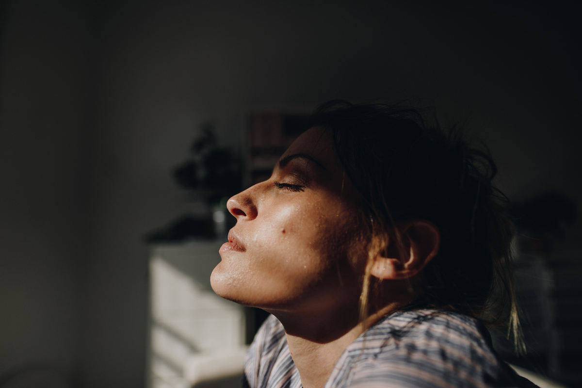 Woman getting sun from inside