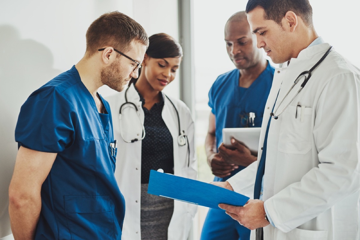 group of doctors and nurses standing in hallway, school nurse secrets