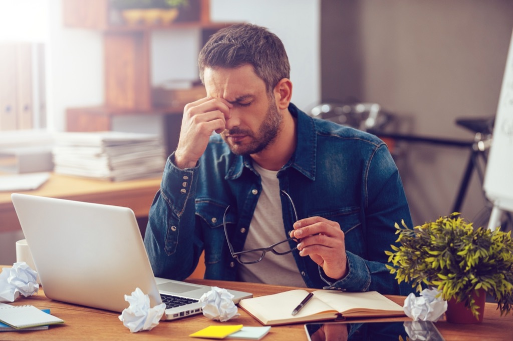 Man stressed at work, in dire need of one of the best stress busters.