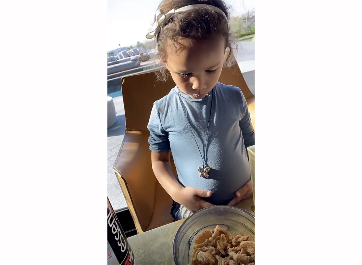 screenshot from chrissy teigen's instagram story of luna eating pork rinds