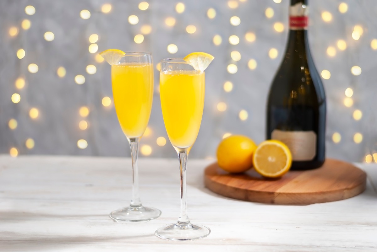 two glasses of mimosa, with lemon