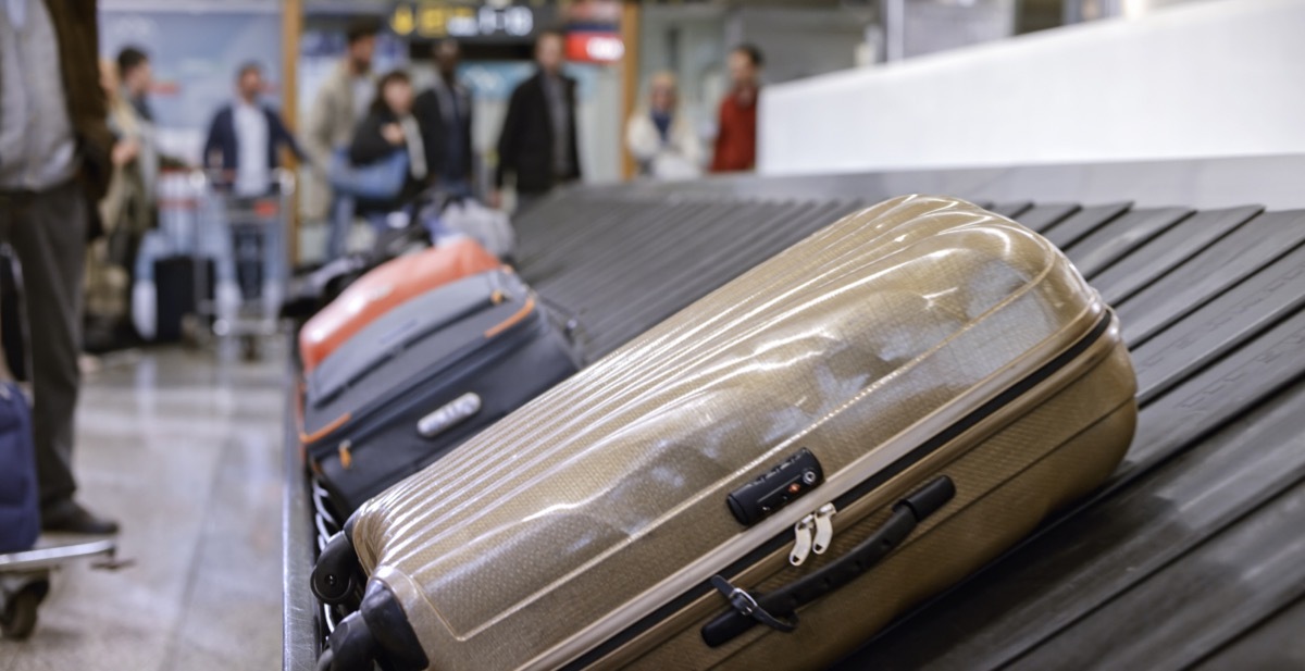 Business people standing at baggage claim in airport.