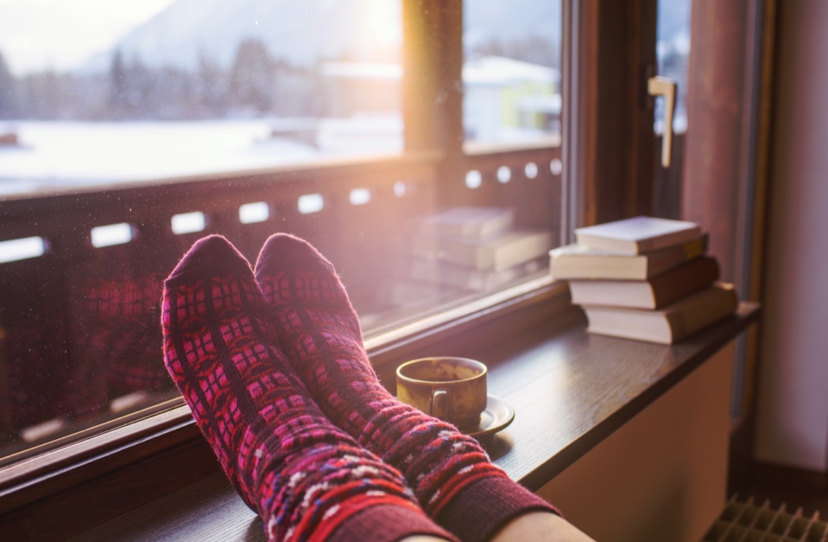 Feet in woollen socks by the mountains view