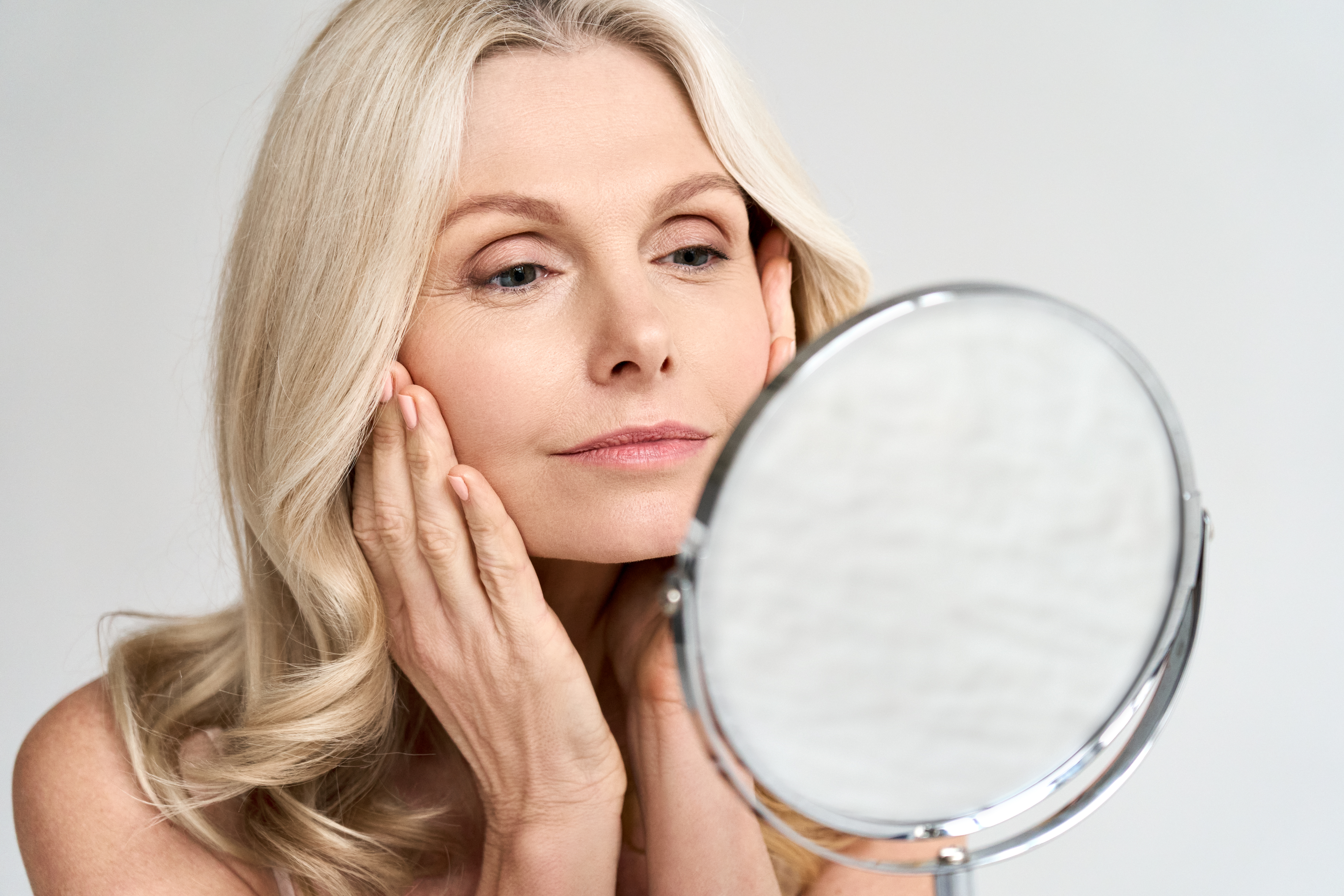 Woman Checking Skin in Mirror