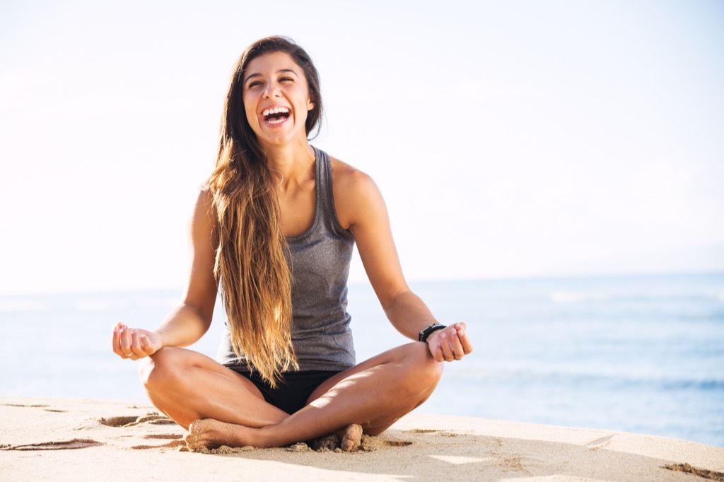 Woman doing yoga, finding balance.