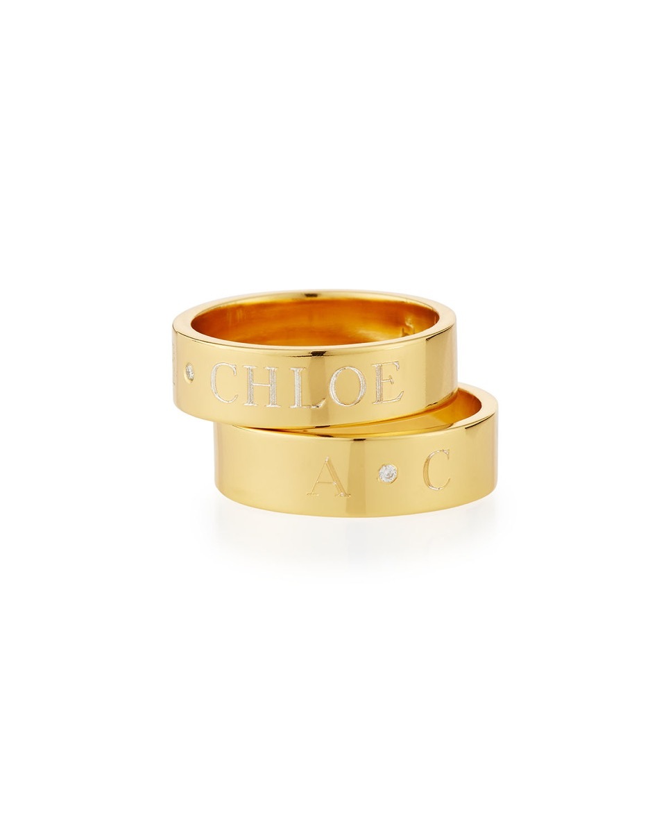 Two stacked gold rings, white background