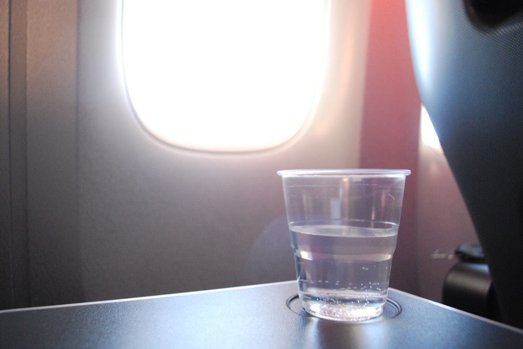 cup of water on an airplane tray table