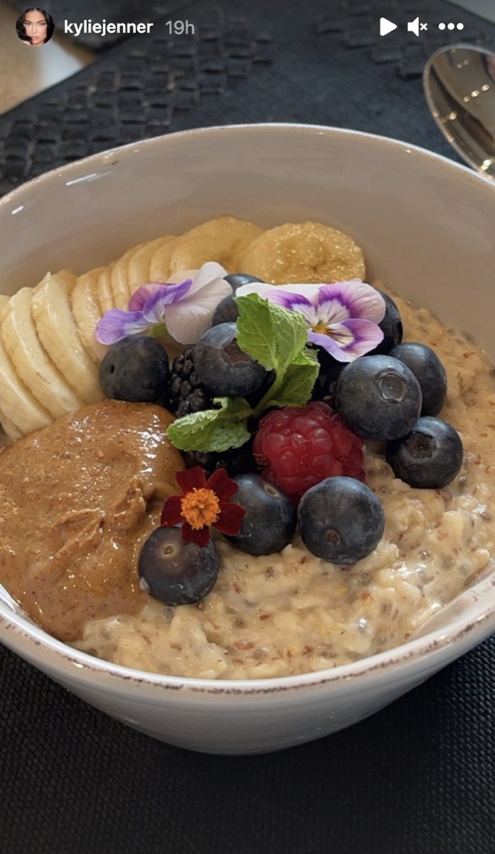 bowl of oatmeal with berries and flowers