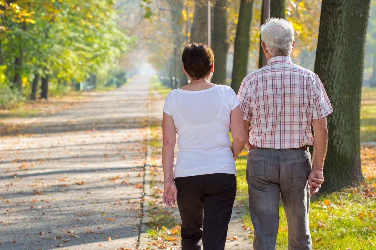 Elderly couple walking outside in the morning sunshine