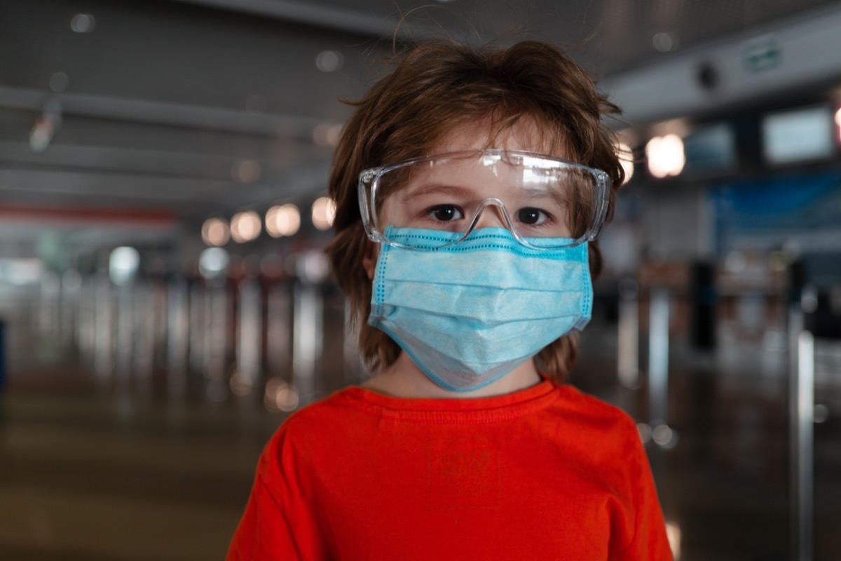 Child face in a mask and goggles.