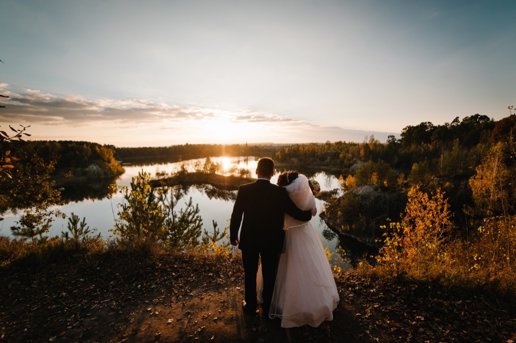 bride and groom looking at sunset this is the age most people get married in every US state