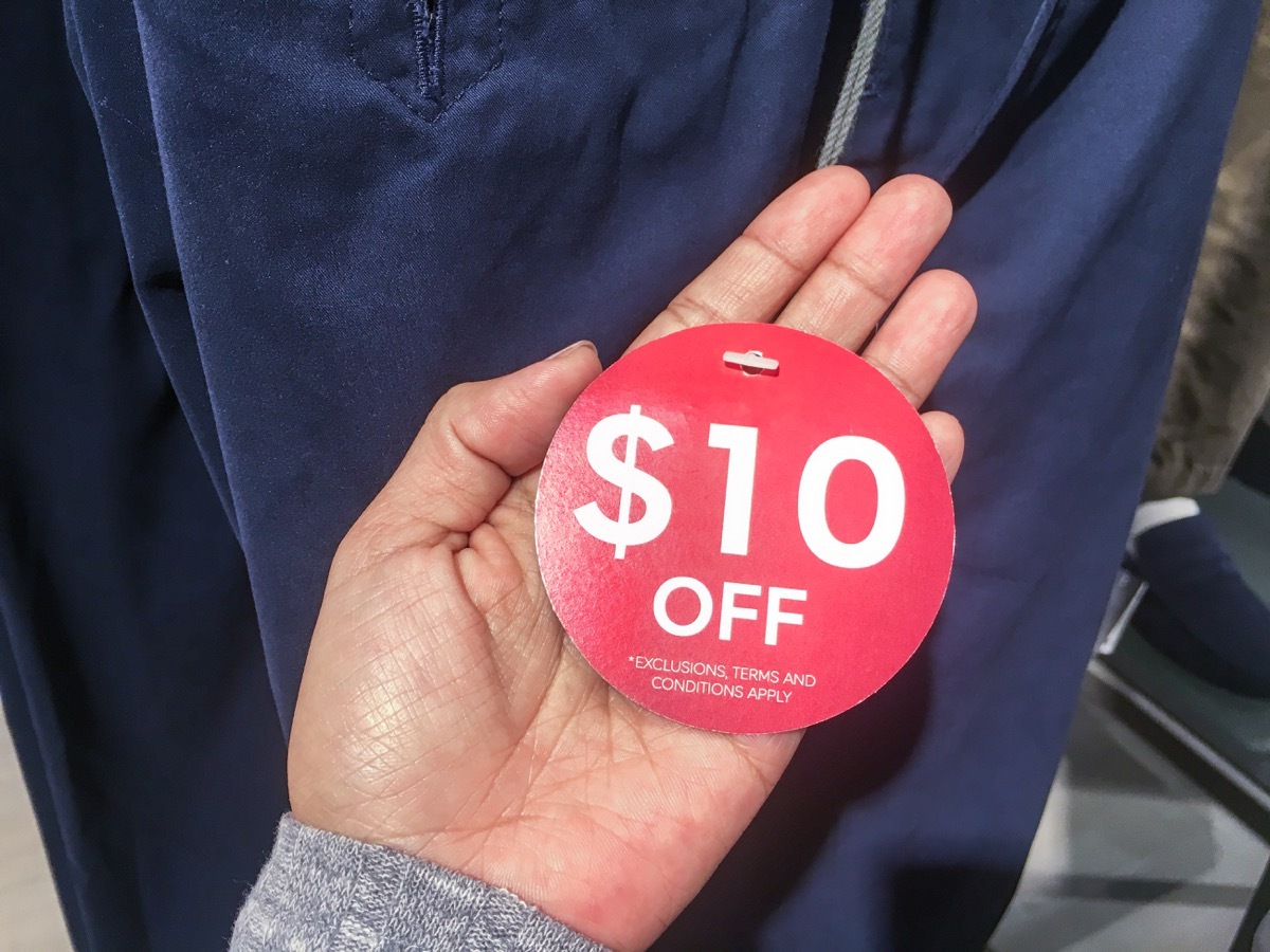 woman holding $10 off sale