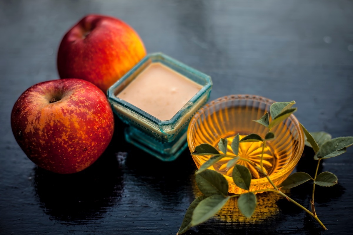 apple pulp mixed with honey to normalize skin which becomes dry in winter on wooden surface