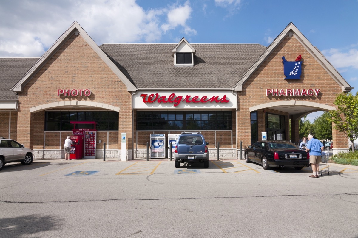 Customers outside a Walgreens drug store on a summer day