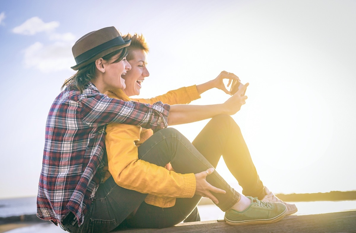 Young female couple laughing on date