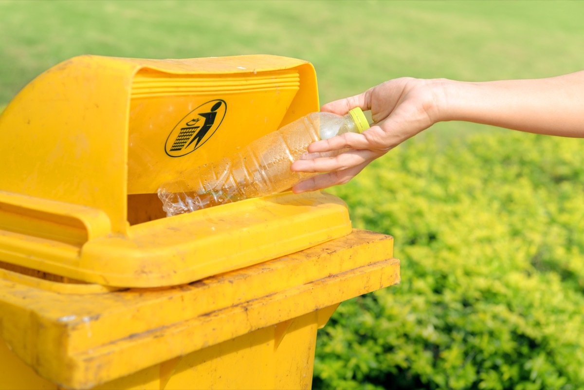 Throwing water bottle in garbage