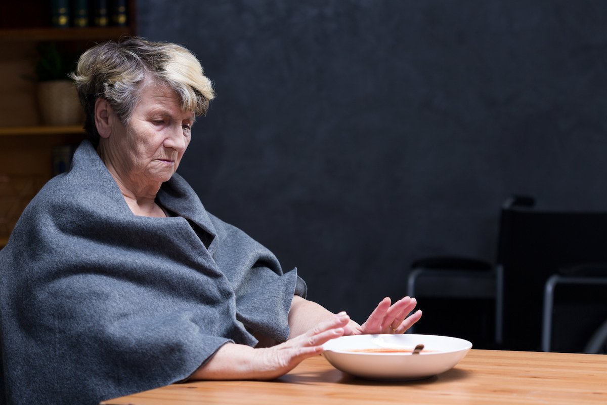 Elderly woman refusing to eat meal