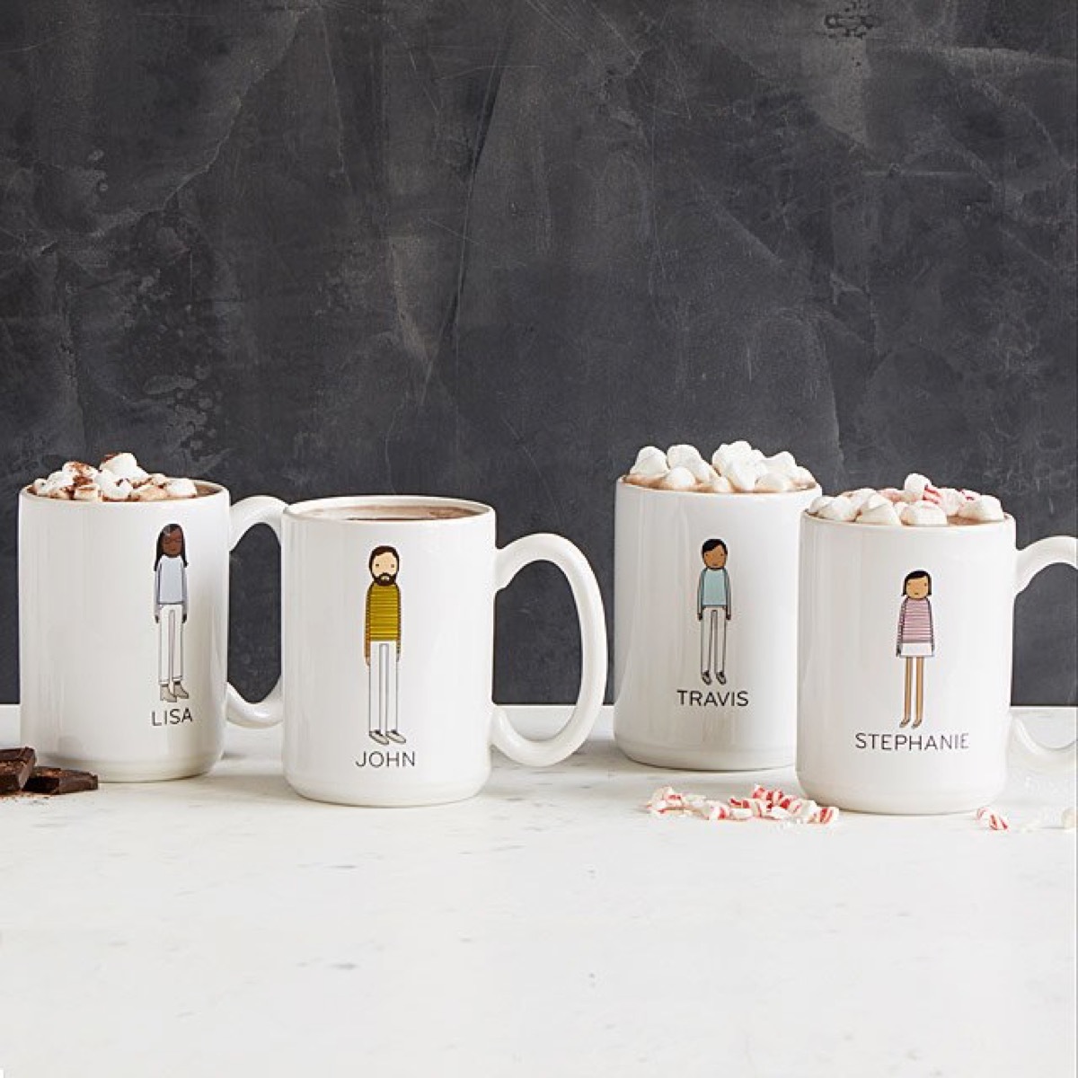 four white mugs with cartoon images and names on them