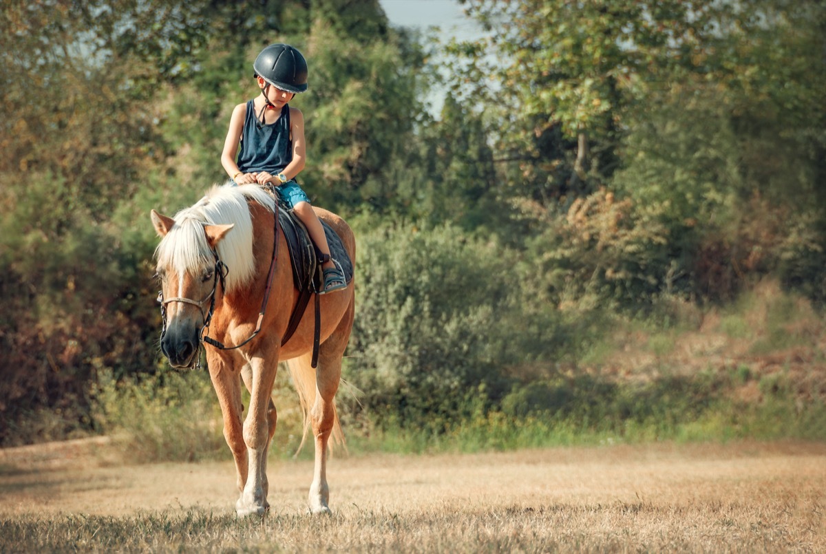 boy riding a horse