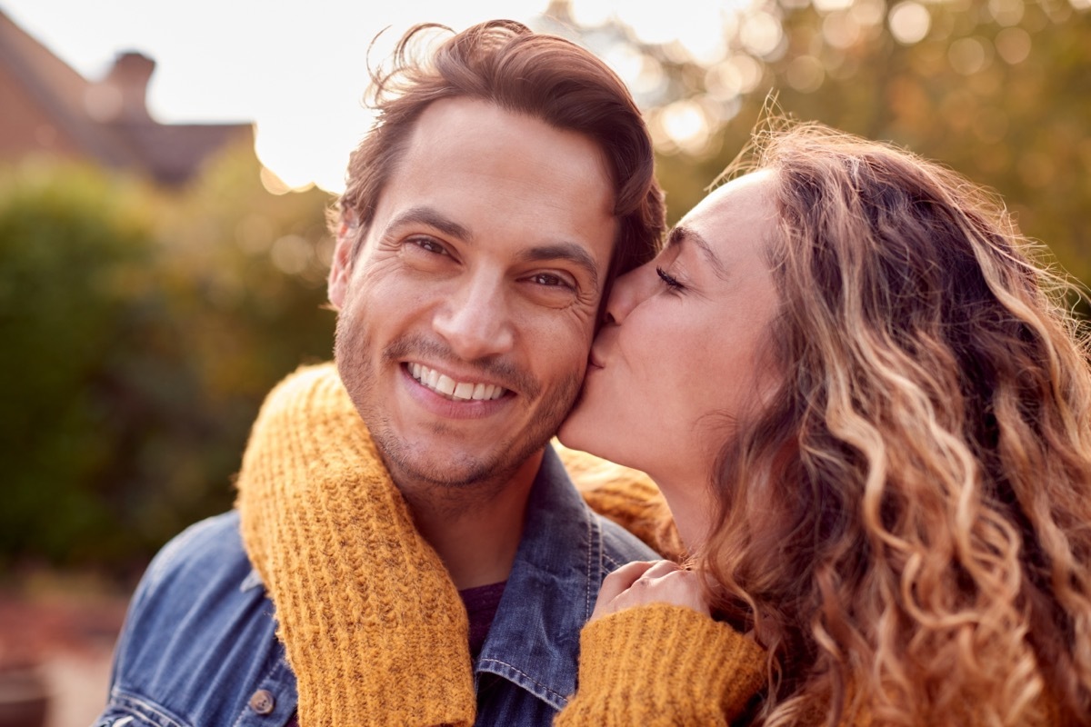 woman kissing man on the cheek