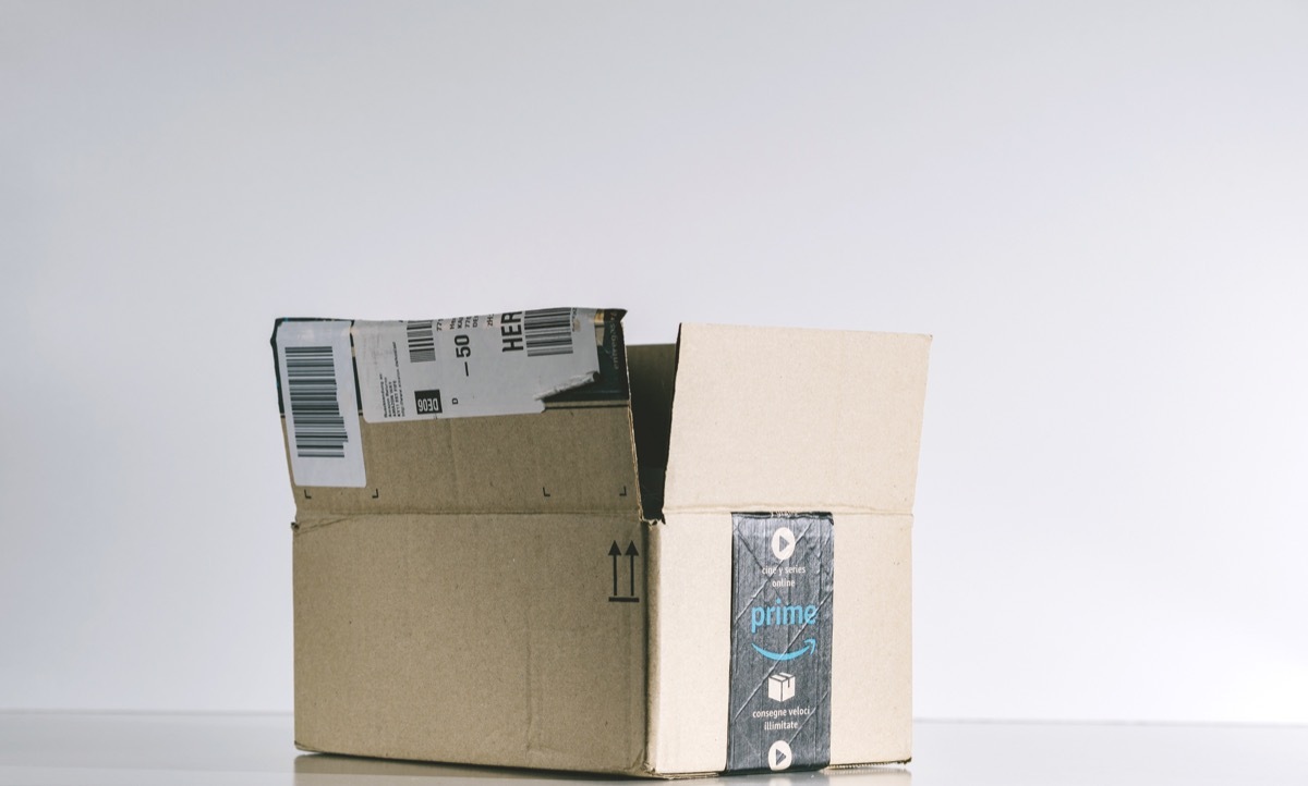 PARIS, FRANCE - JUL 30, 2017: Open Amazon Prime cardboard box side. Amazon is an American electronic e-commerce company distribution worlwide e-commerce goods