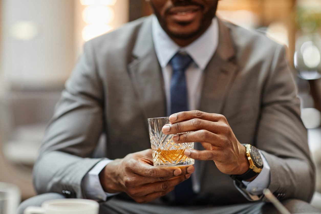 Man holding a glass of alcohol.