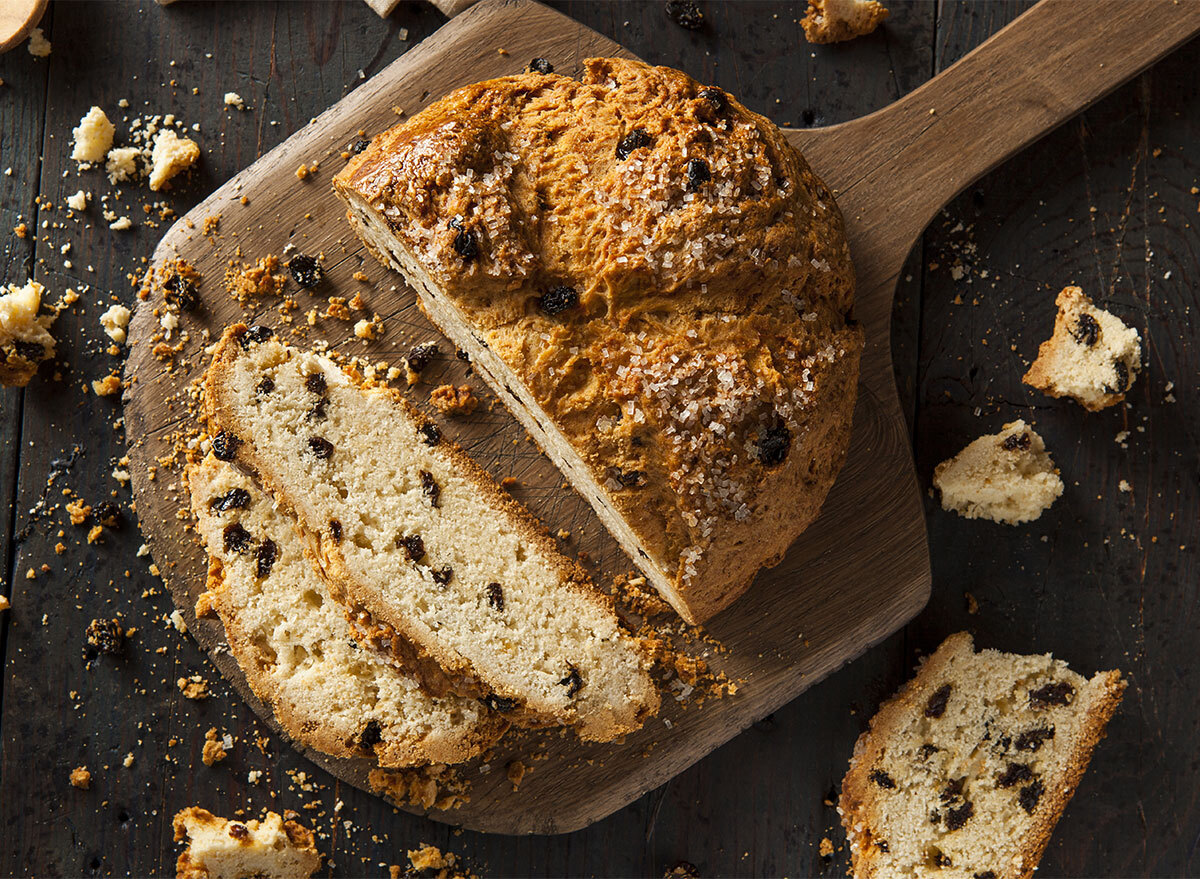 loaf of irish soda bread on cutting board with slices