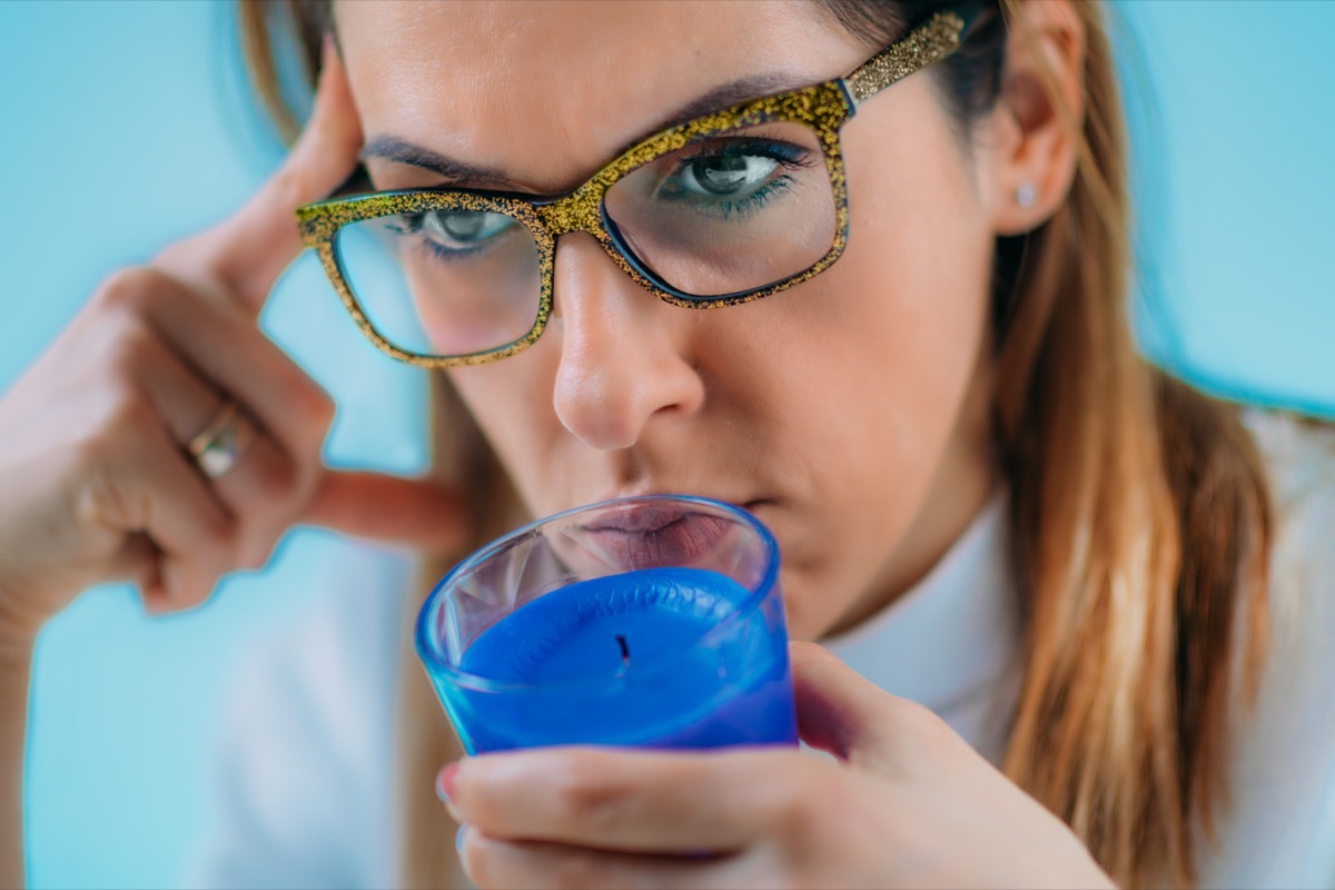 Woman Trying to Sense Smell of a Candle